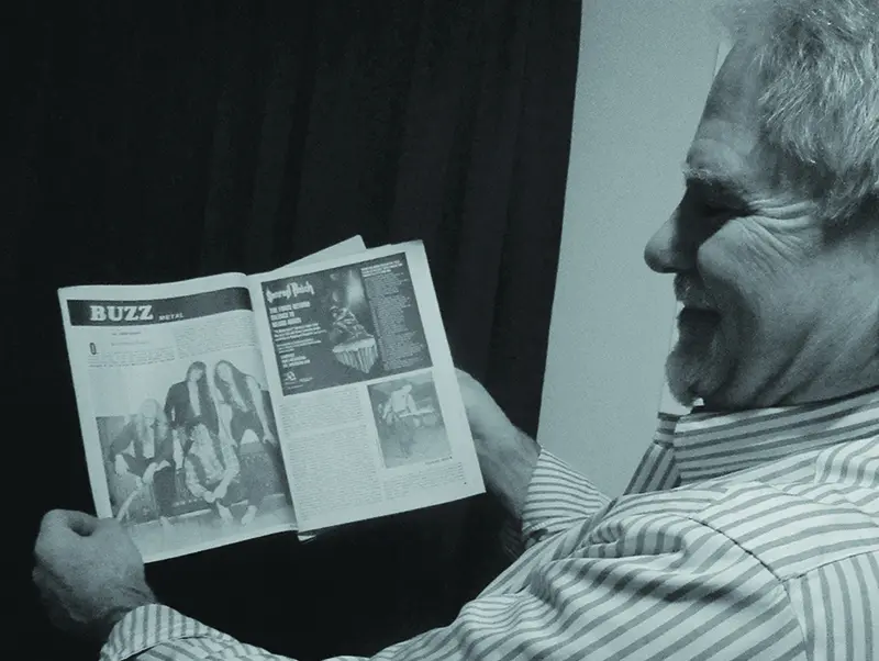 George Guarino with a copy of Buzz Magazine.
